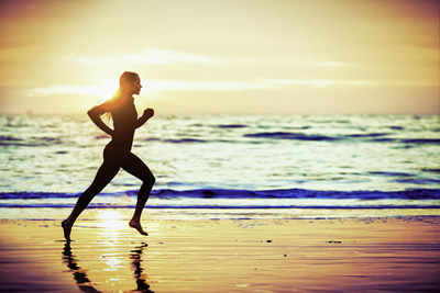 perosn running on beach